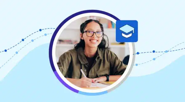 Student smiling at desk.