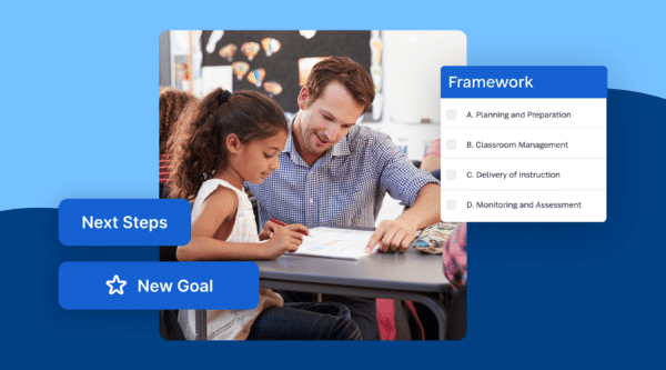 Male teacher with girl student looking at table reviewing work