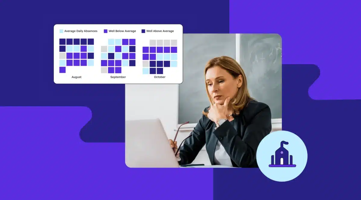 School leader looking at laptop with attendance charts displayed above.