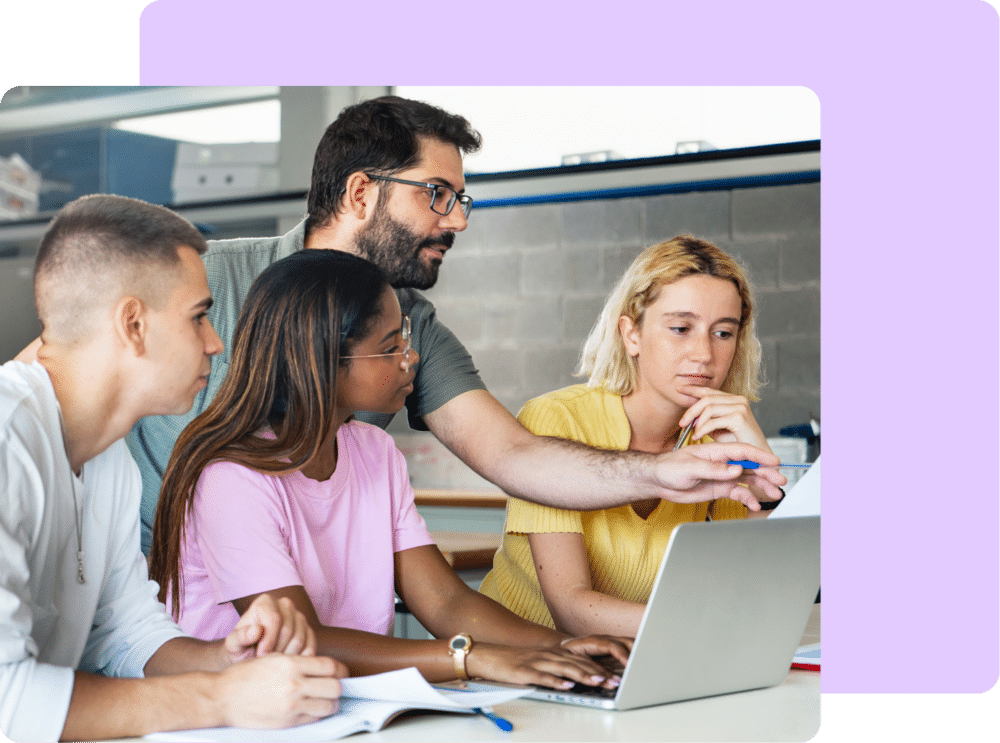 Attend-demo-pg-hero-img photo of teacher helping high school students on computer