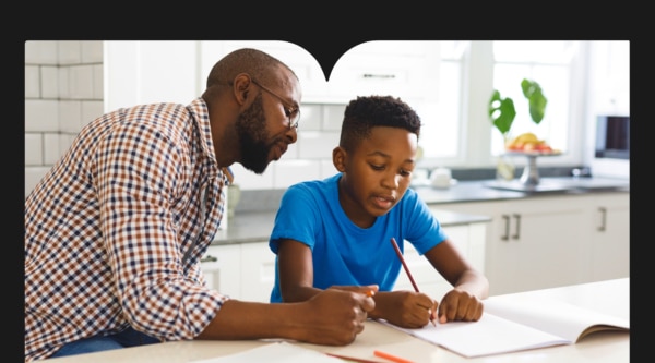 Father Helping HIs Young Son with Homework