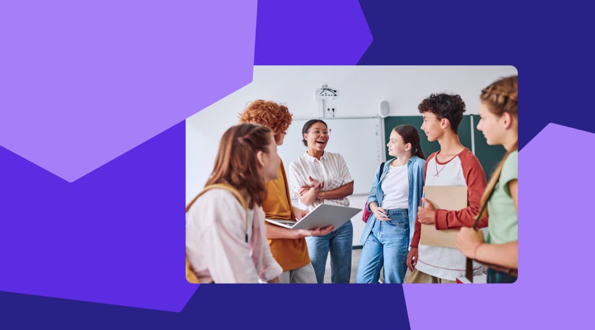 Photo of a teacher talking to a group of students.