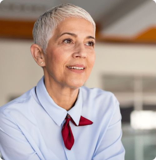 Woman with short hair in a white shirt.